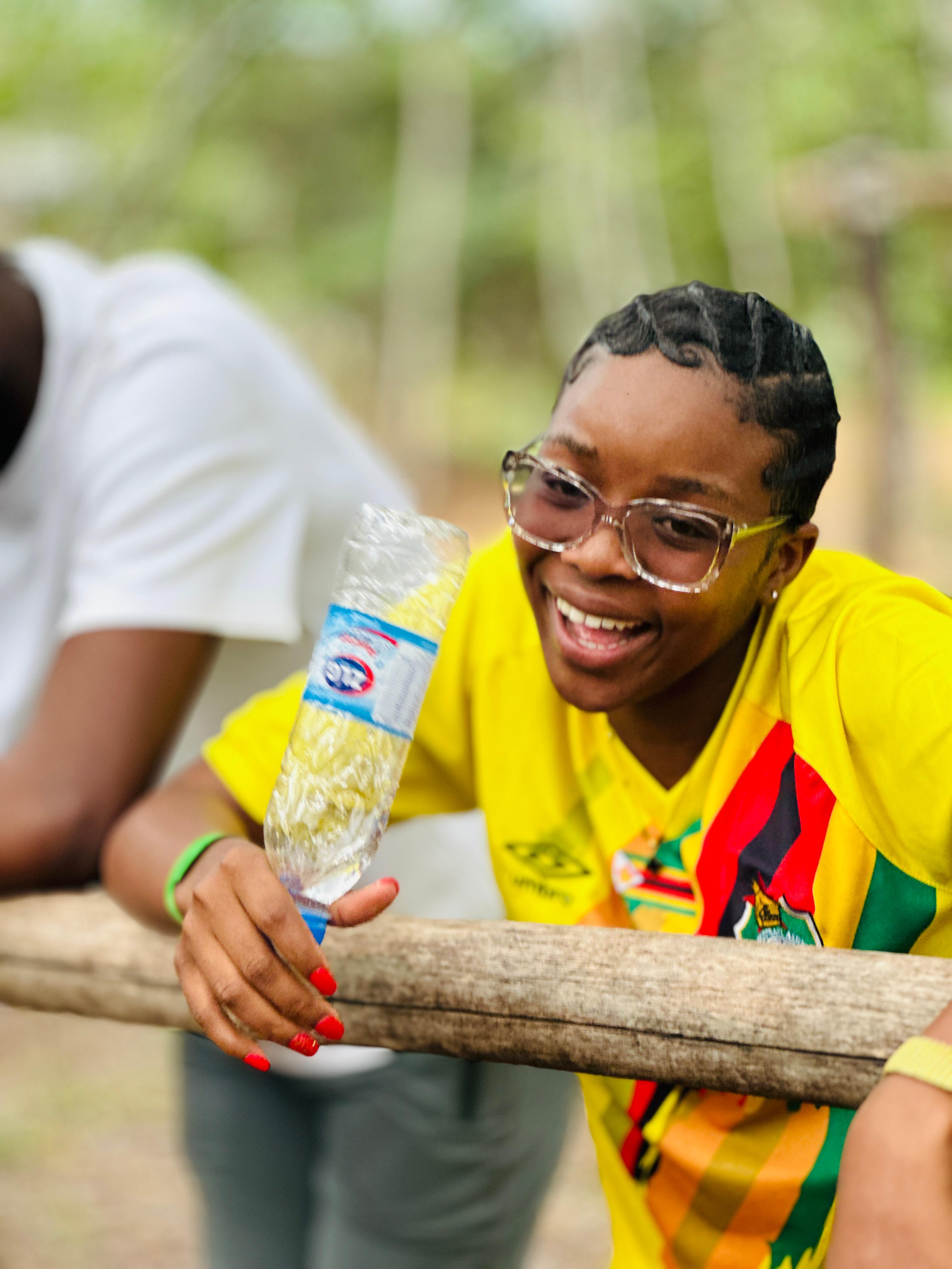 Young woman laughing with friends at camp