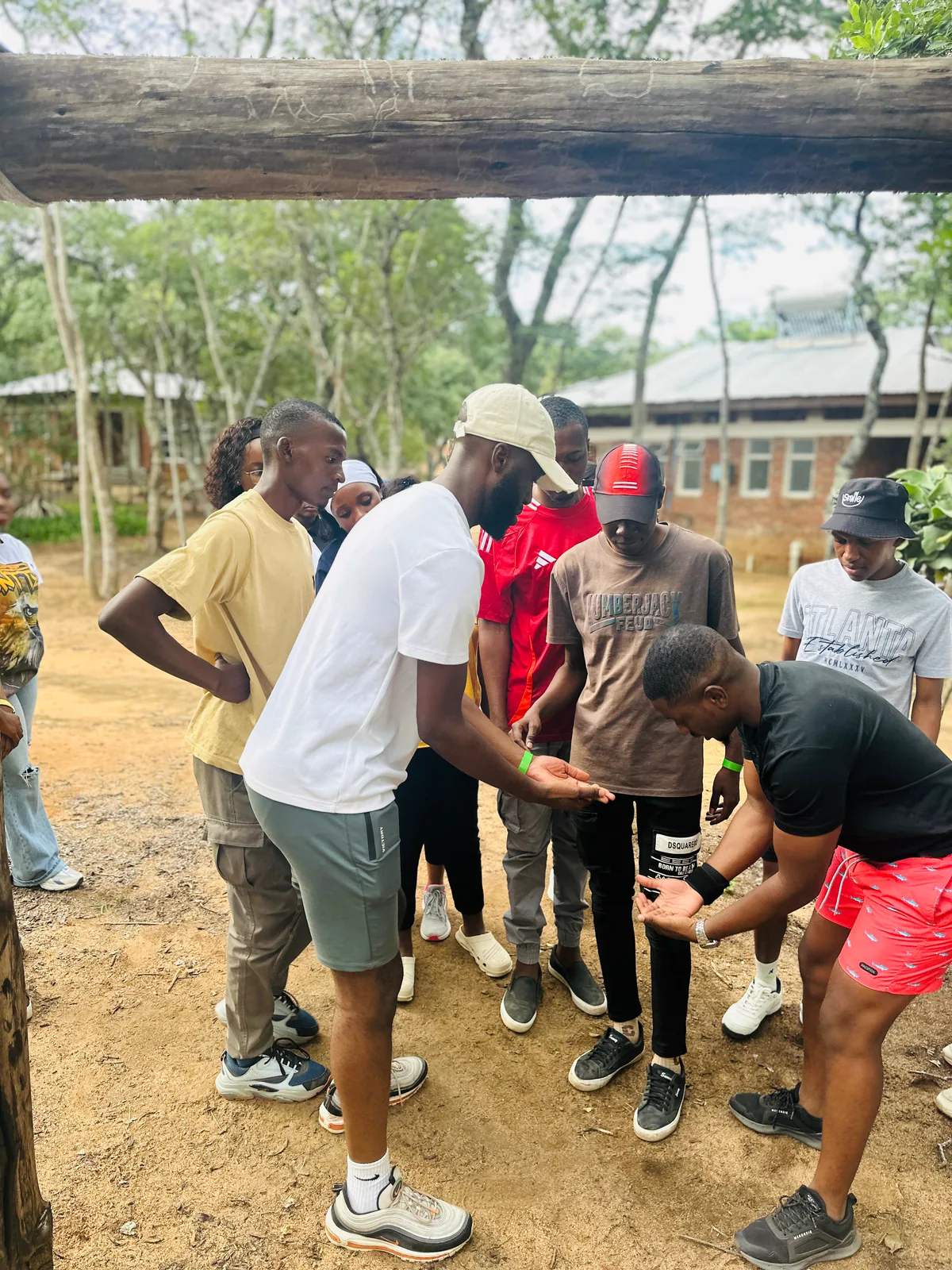 Camp participants working together during an outdoor team challenge