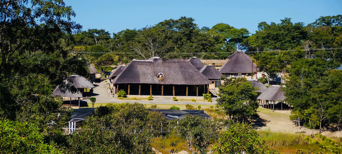 Wide view of the thatched lodge buildings at Karumazondo Resort